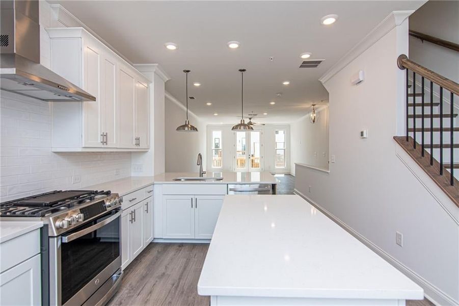 Modern Kitchen with Gas Cooktop , Vent Hood , Dishwasher and Built in Microwave . Not the actual unit previously built