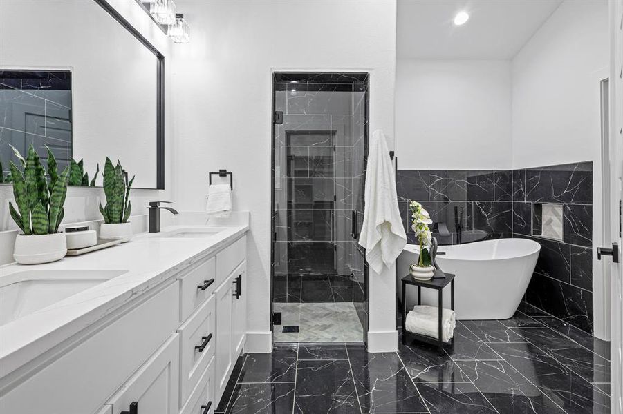 Bathroom with vanity, tile walls, and plus walk in shower