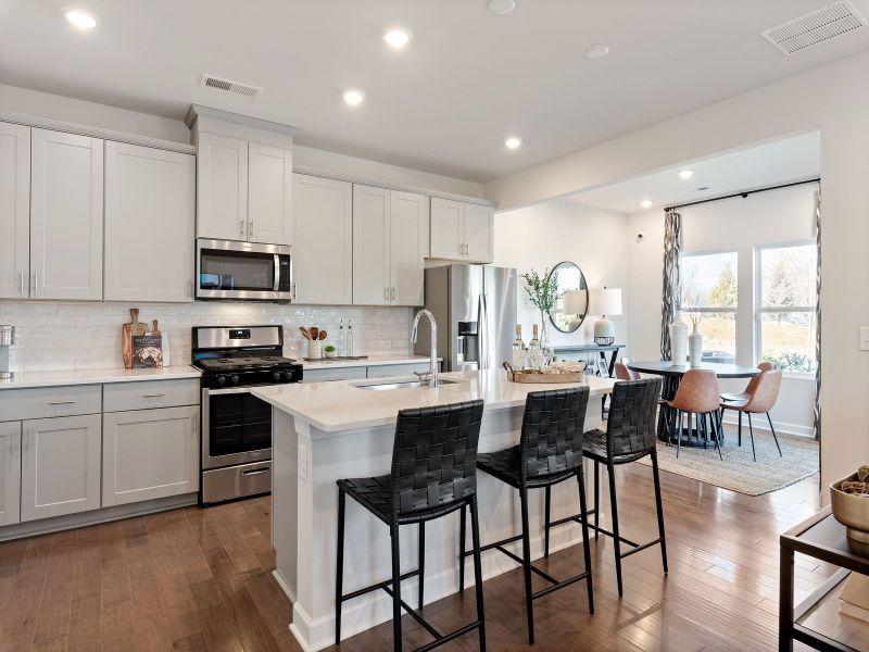 The well-appointed kitchen with a large island and generous pantry makes meal prep a breeze.