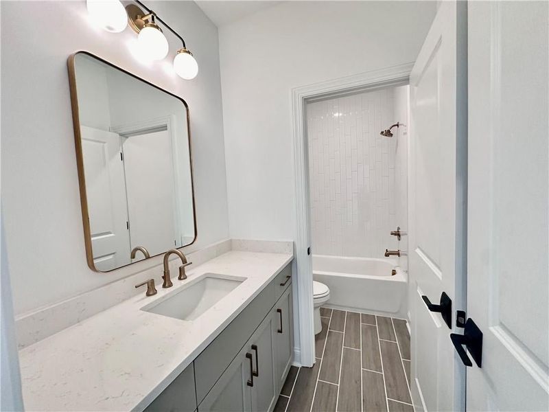 Guest bathroom complete with tile to the ceiling