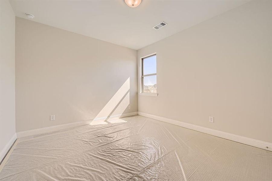 Carpeted spare room with vaulted ceiling