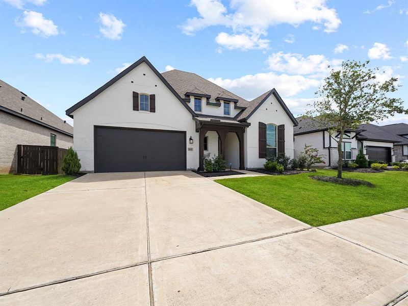 Exceptional curb appeal, featuring a charming light brick exterior beautifully accented by dark wood trim. This eye-catching combination creates a warm and inviting atmosphere that instantly draws you in.