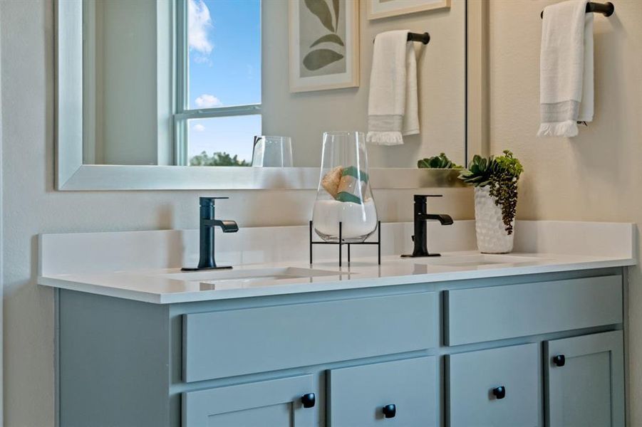 This primary bathroom is definitely move-in ready! Featuring an oversized tub with tile surround, walk in shower, stained cabinets with light countertops and dual vanities, high ceilings, custom paint, sleek and dark modern finishes.