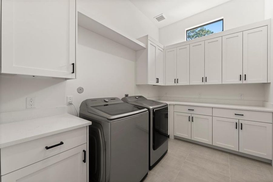 Utility room offers plenty of storage and function.