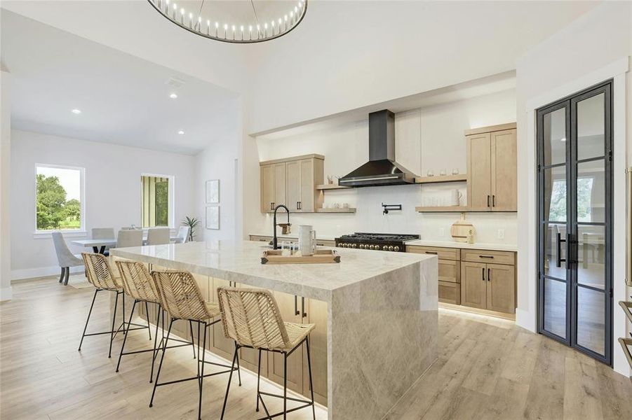 This kitchen encompasses high end KraftMade cabinetry, custom iron pantry doors, 48in gas cooktop, double oven, abundant LED lighting (under cabinet, over cabinet, and toe kick lighting).