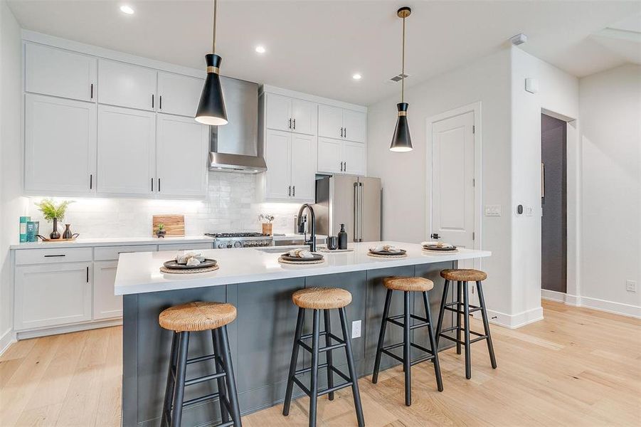 The kitchen, featuring an oversized island, is perfect for entertaining, offering ample space for meal prep, dining, and socializing, making it the ideal gathering spot for friends and family.