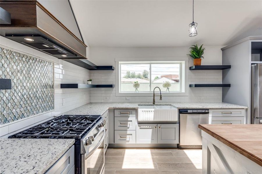 Upgraded appliance package including  oversized burners ,  high end fridge , commercial grade custom vent hood all make this a kitchen to make your friends JEALOUS!