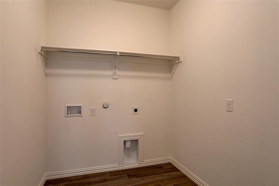 Washroom featuring gas dryer hookup, hookup for an electric dryer, washer hookup, and dark hardwood / wood-style flooring