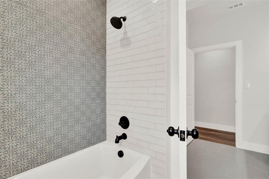 Hall bathroom tile and black fixtures