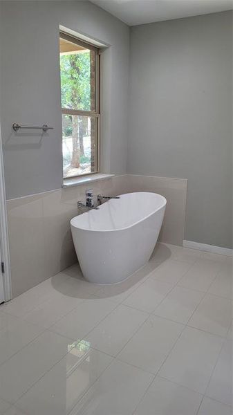 Bathroom with tile patterned floors and tile walls