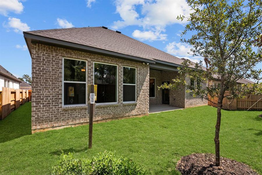 Full brick exterior w/full gutters and covered rear patio!