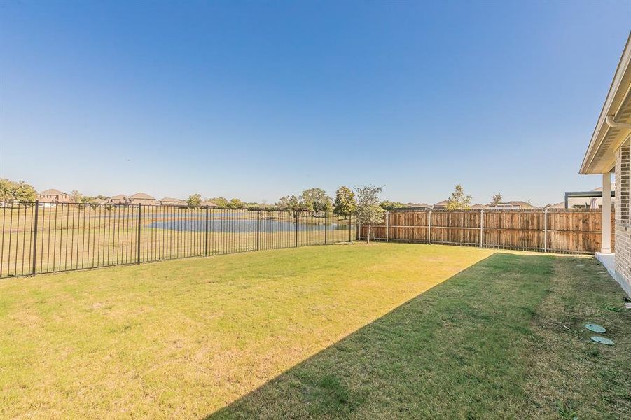 View of yard with pond