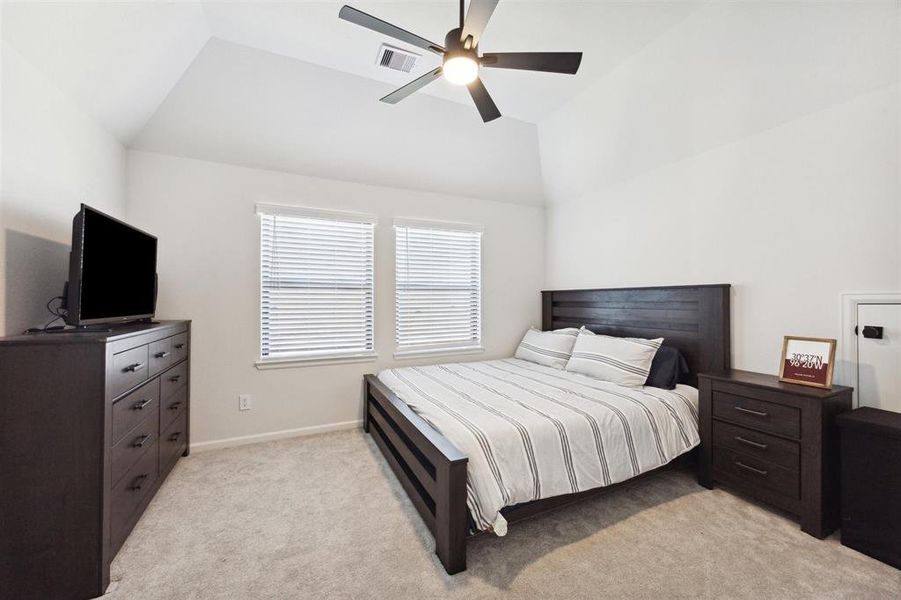 Another secondary bedroom with vaulted ceilings.