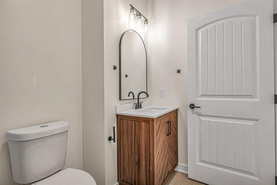 Guest bath also has stained wood vanity.