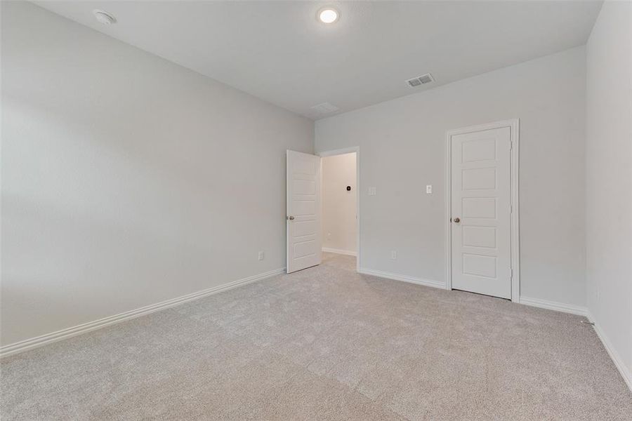 Spare room with light colored carpet