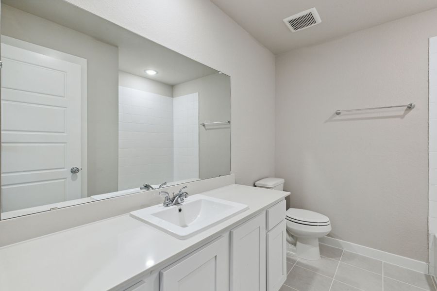 Bathroom in the Oak home plan by Trophy Signature Homes – REPRESENTATIVE PHOTO