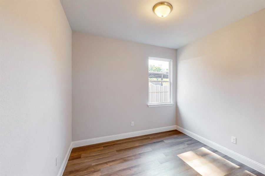 Unfurnished room featuring wood-type flooring