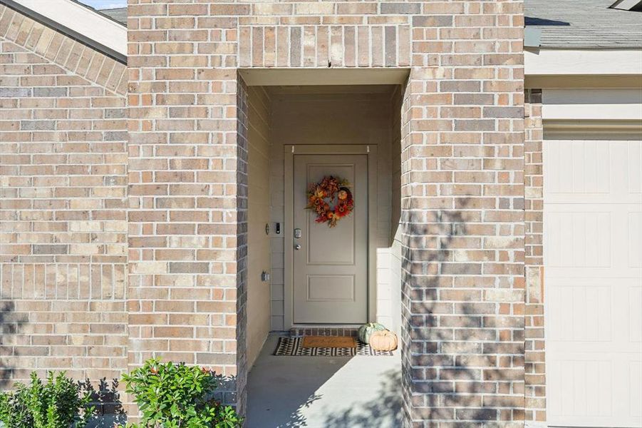 Doorway to property with a garage