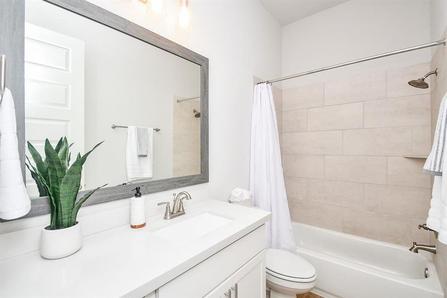 Full size bathroom with shower/bath combo.