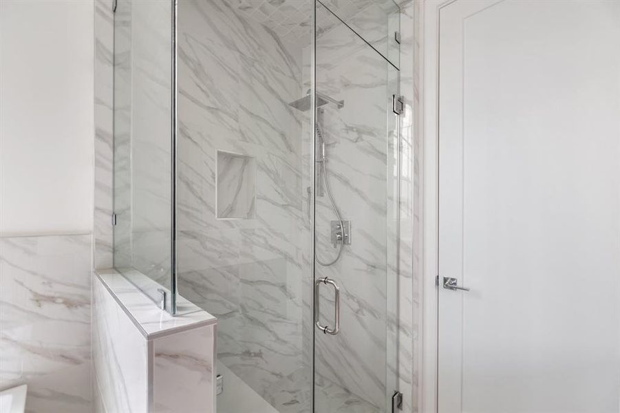 High end details include Delta Premium widespread faucets, all-frameless glass shower enclosures with matching hardware trim, and solid brass premium bathroom accessories in polished chrome. A perfect blend of form and function.