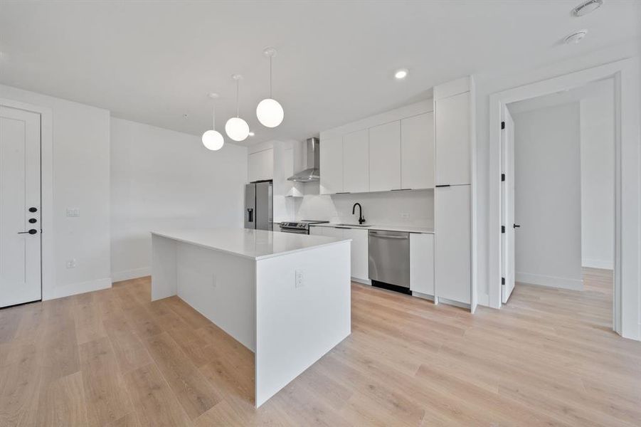 Unit 307 features the "Cool" finish scheme which includes modern white cabinetry in the kitchen, black pulls and fixtures, Carrara marble-style quartz countertops, plus a full Samsung appliance package. *Photo to show finish-scheme only.*