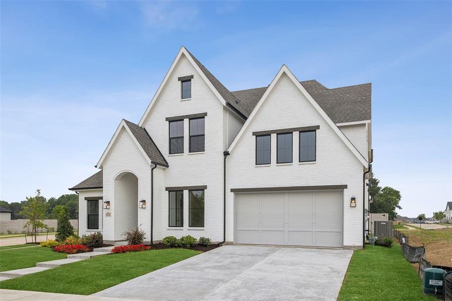 This stunning elevation with painted brick and cedar headers creates a home with the curb appeal you have been searching for!