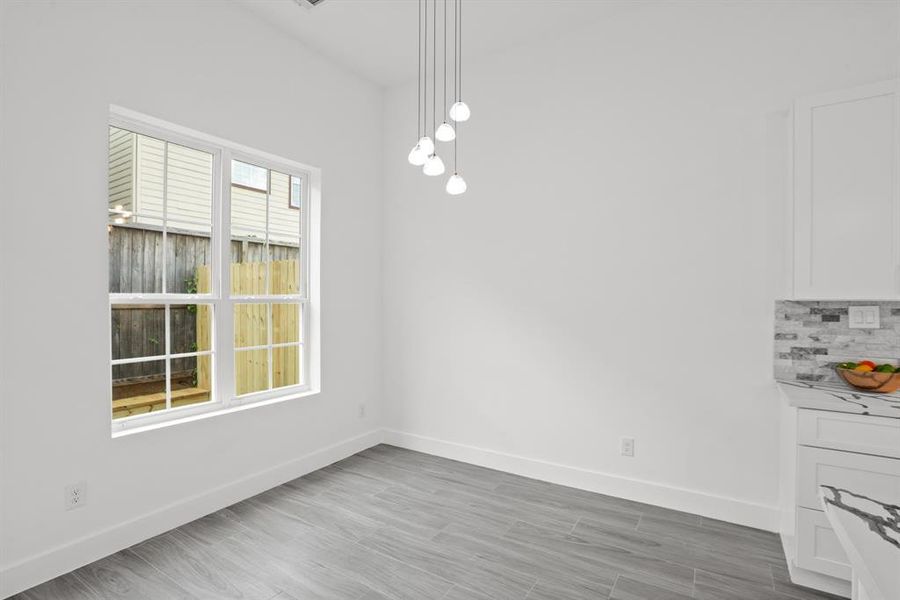 The dining space features a custom lighting feature.