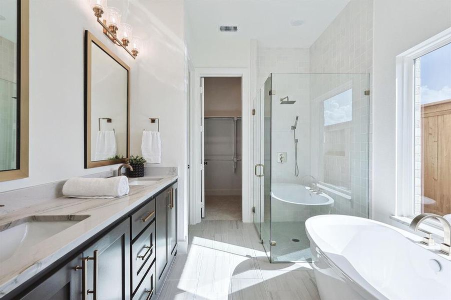 Bathroom featuring tile floors, independent shower and bath, large vanity, and dual sinks