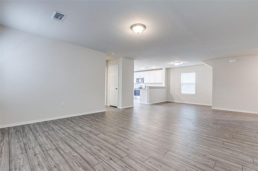 Unfurnished living room with light hardwood / wood-style floors