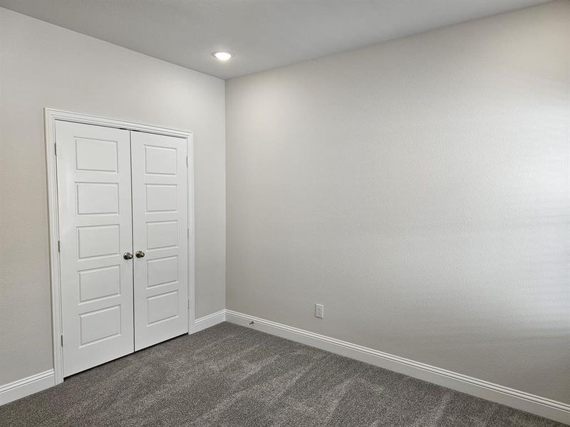 Unfurnished bedroom with carpet and a closet