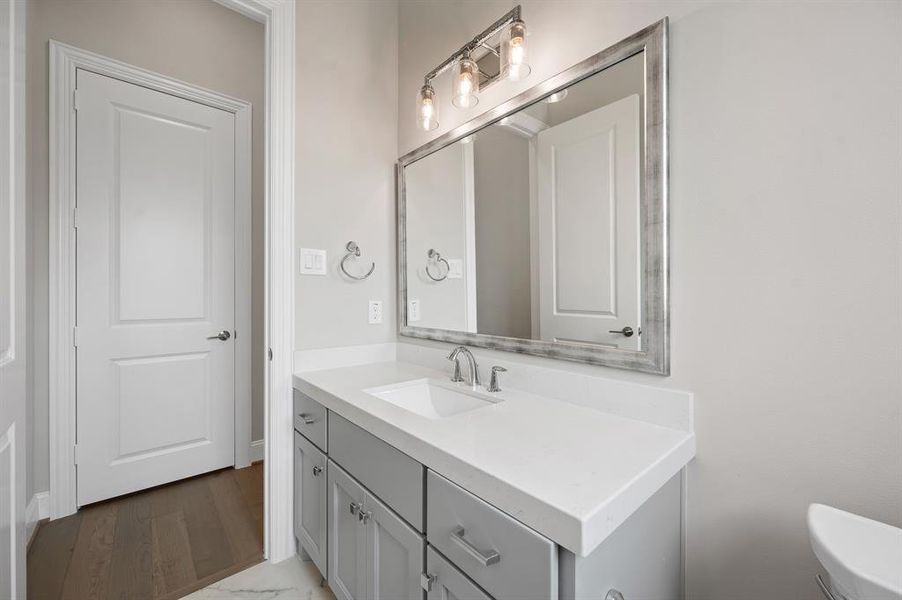 The downstairs half bath has easy access to guests
