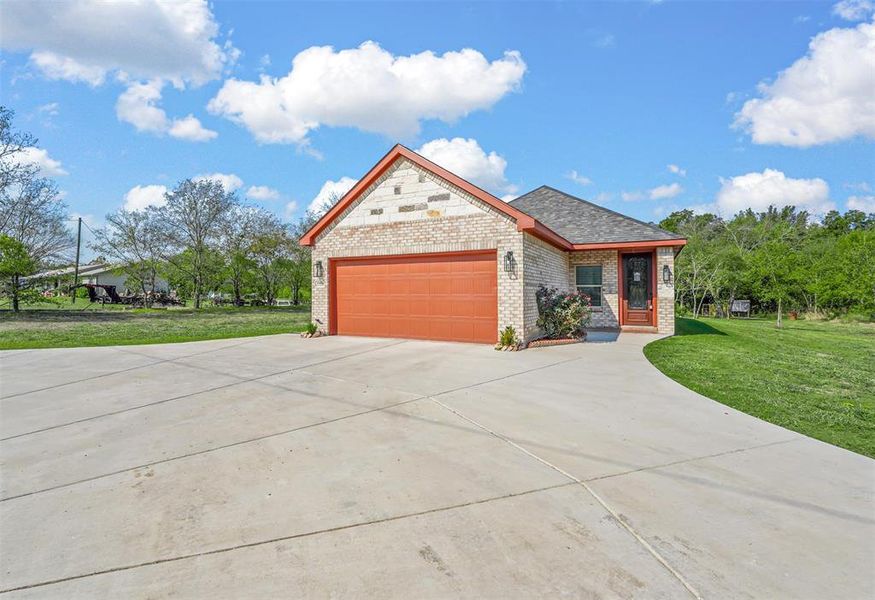 View of Front of Home with Garage (EV Charger) and Circle Drive