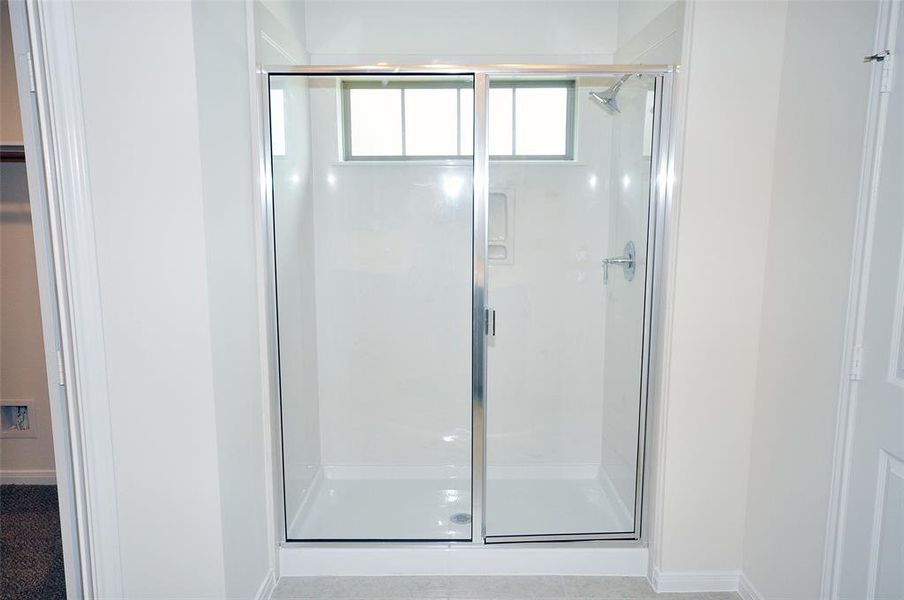 Enjoy this large shower with easy care cultured marble surrounds.