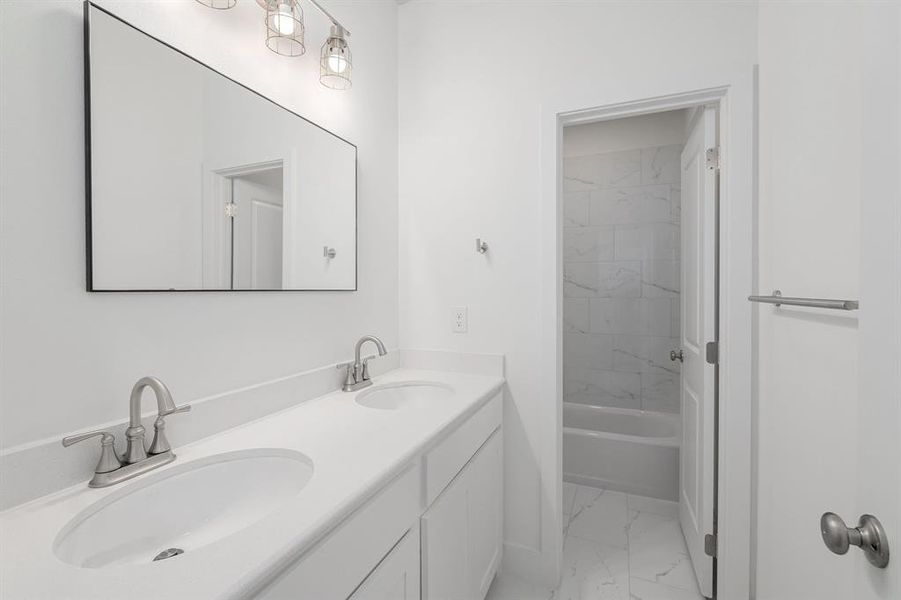 Bathroom featuring vanity and tiled shower / bath combo