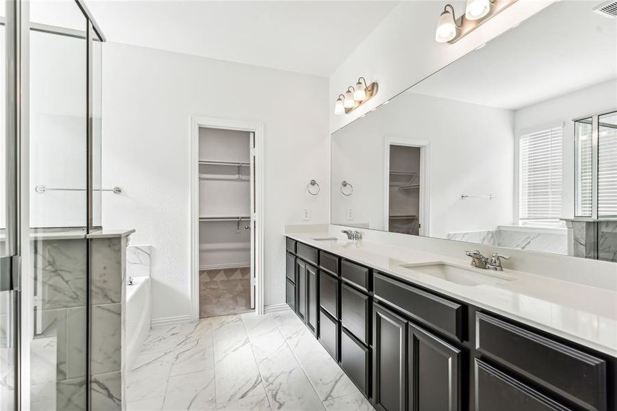 Bathroom featuring a washtub and vanity