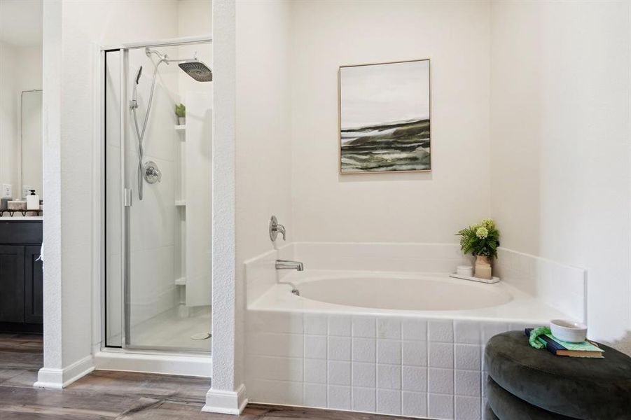 Bathroom featuring vanity, shower with separate bathtub, and hardwood / wood-style floors