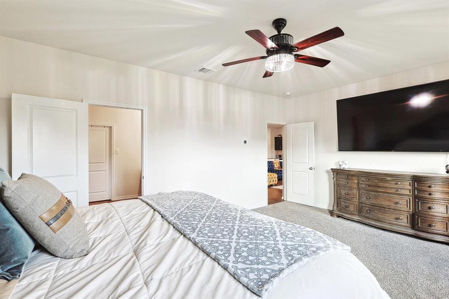 Bedroom featuring light carpet and ceiling fan