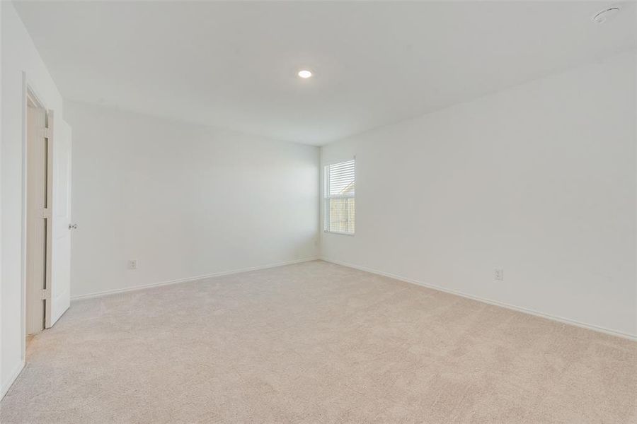 Spare room featuring light colored carpet