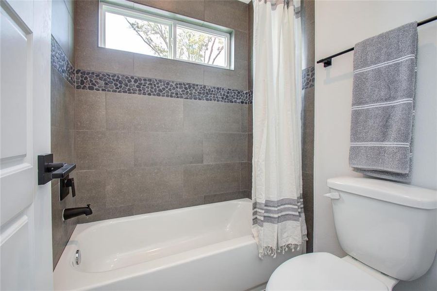 Secondary bathroom with tub/shower combo. Model home photos - FINISHES AND LAYOUT MAY VARY!