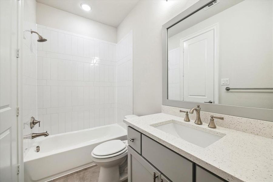 Each secondary bath boasts stylish design and modern amenities, featuring sleek fixtures, tiled floors, and ample storage space.