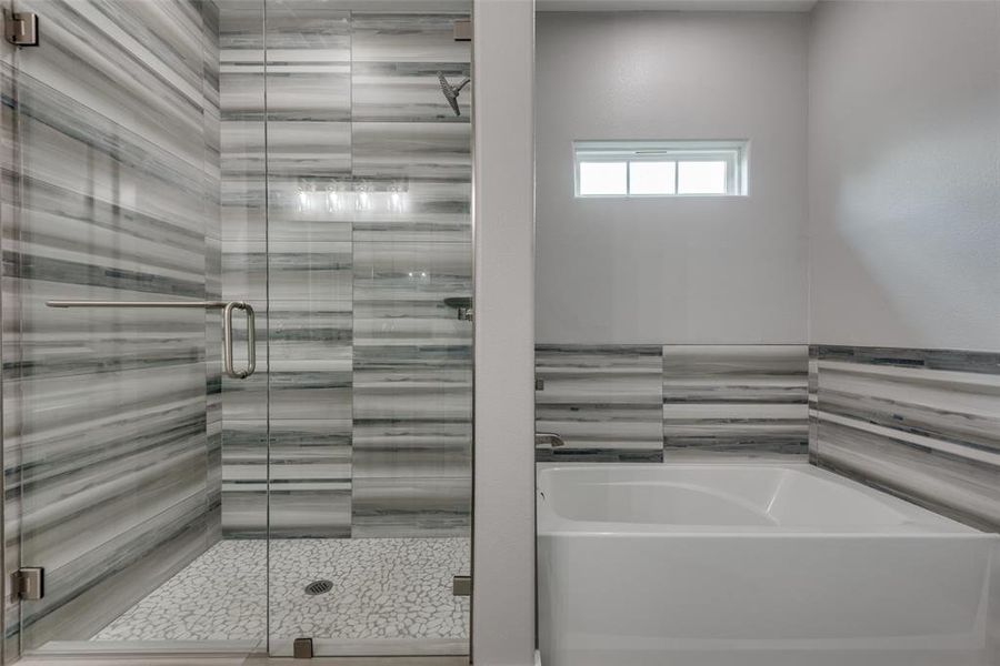 Relax in this oversized tub or enjoy this large walk-in shower!