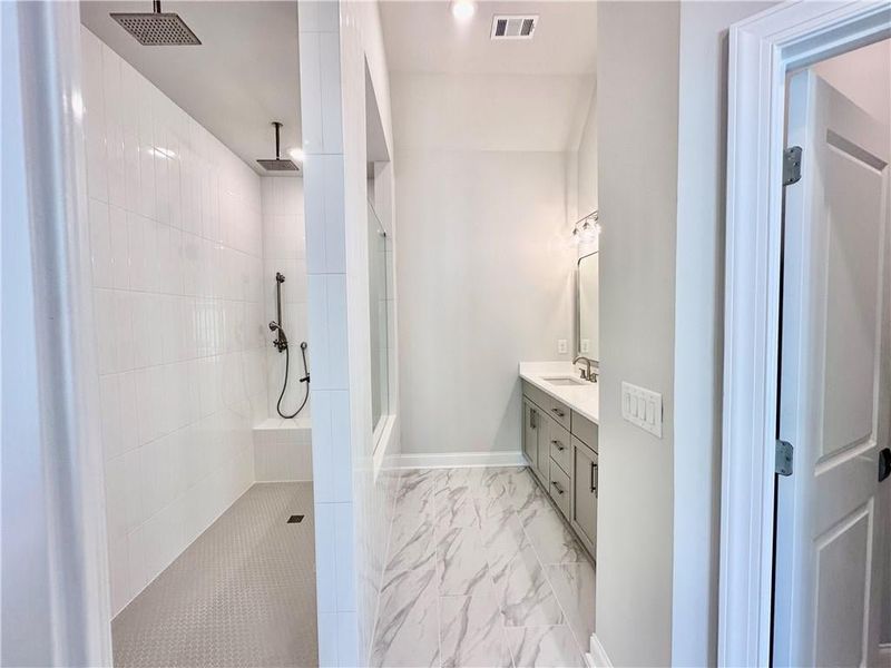 Owners, bathroom, showcases, gorgeous, walk-through, shower, outfitted with multiple rain, showerhead, handheld, and a wall mount