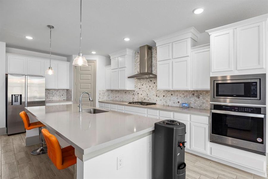 Oversized kitchen with stainless steel appliances and stone countertops makes this a cook's dream.