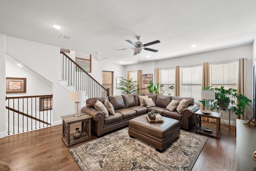 Living room featuring hardwood / wood-style floors and ceiling fan