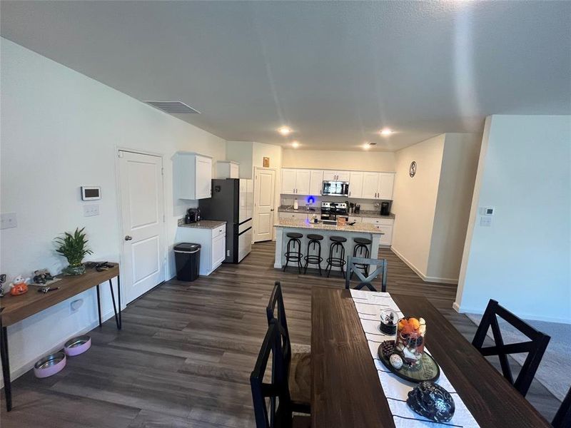 Dining room with dark hardwood / wood-style flooring