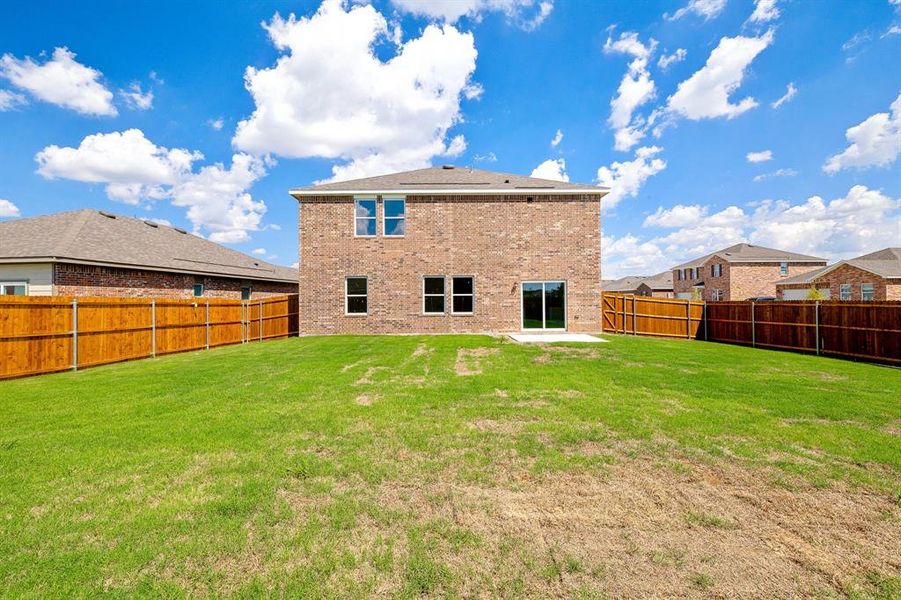 Rear view of house featuring a lawn