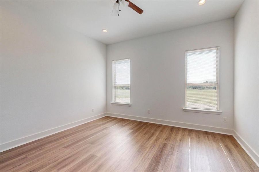 Unfurnished room with ceiling fan and light hardwood / wood-style floors