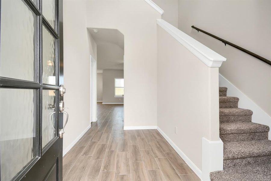 Spacious and inviting home with a stunning entryway – just imagine the possibilities! This beautiful floorplan boasts a grand foyer and open living spaces perfect for entertaining. *This image is from another Saratoga Home with similar floor plan and finishes, not the Brittany floorplan.*