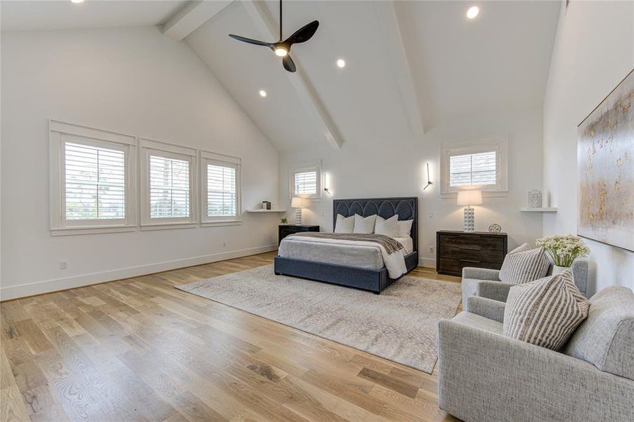 Texas-Size Primary Bedroom with Cathedral Ceiling and tons of natural light through these large windows