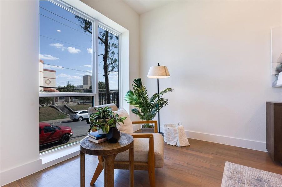 Sitting room with dark hardwood / wood-style flooring